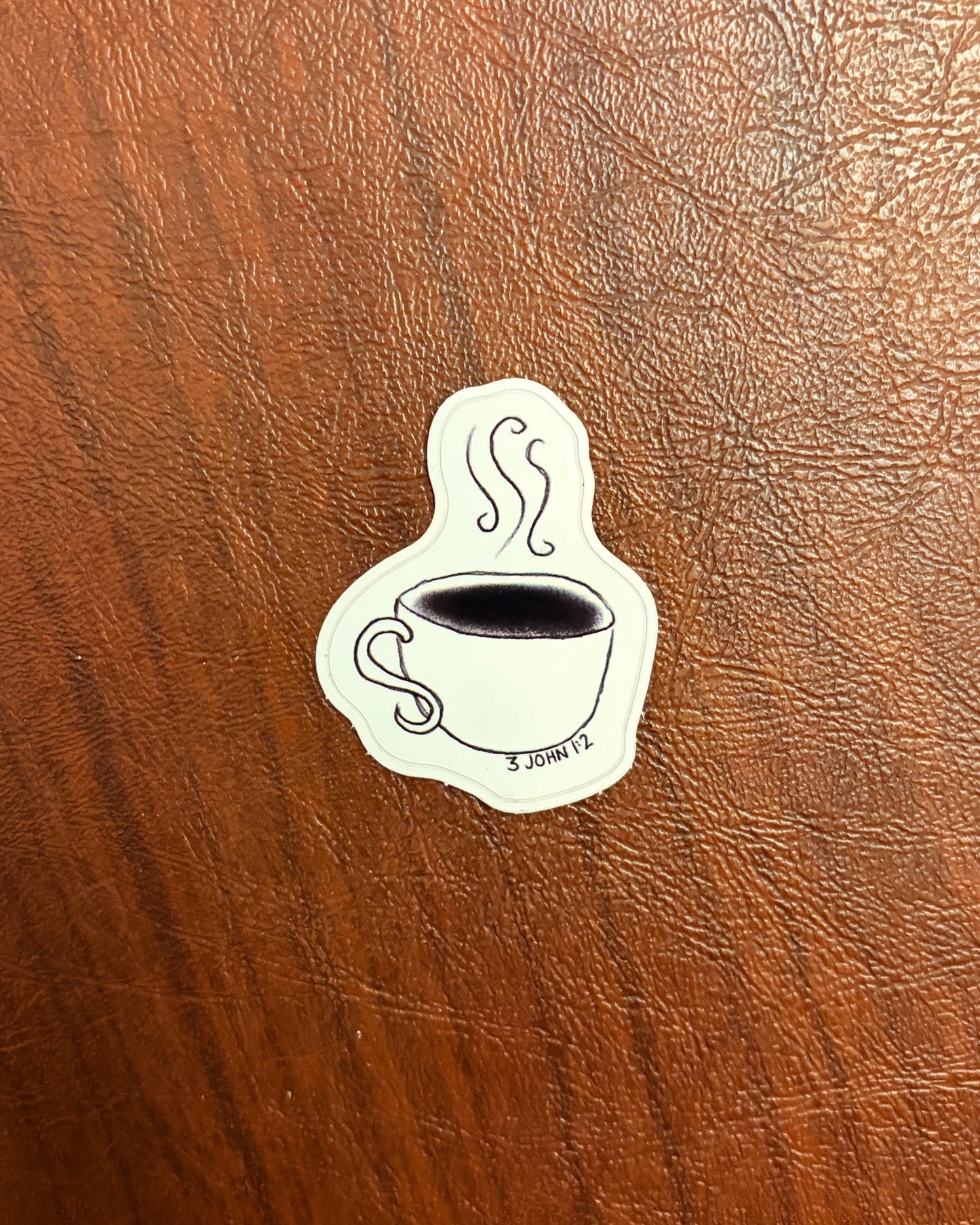 Sticker of a tea cup on a wooden surface