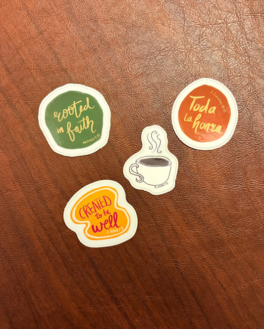 Four motivational stickers on a wooden surface