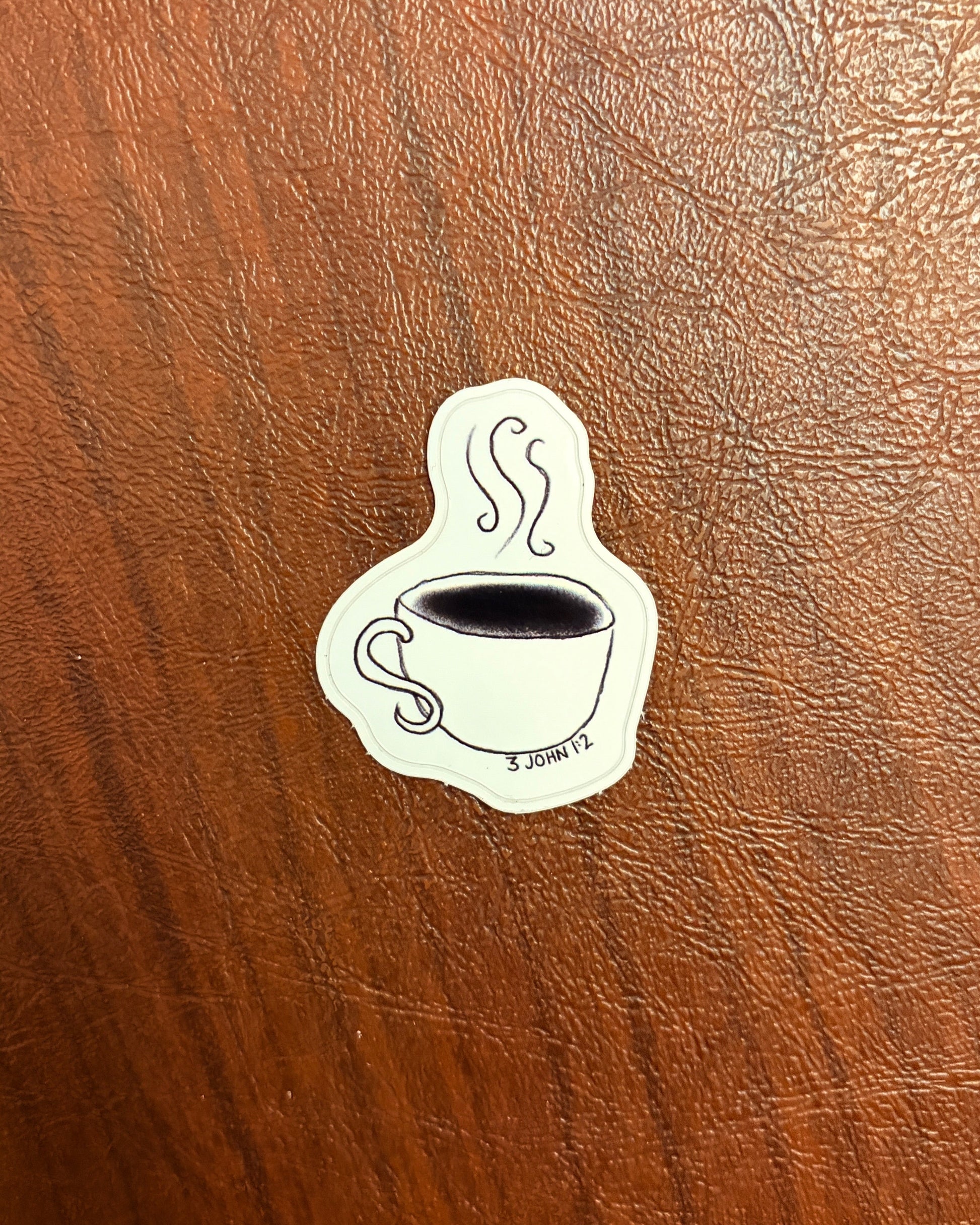 Sticker of a tea cup on a wooden surface